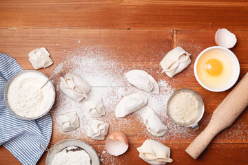 Cooking different types of dumplings: chinese, gyoza (gedza), dim-sum, manty. Top view, copy space