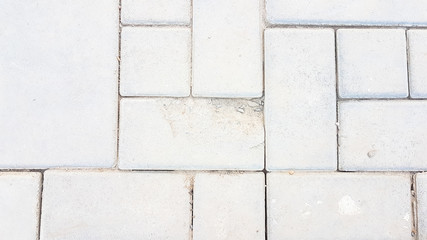 broken square brick concrete walkway with dirty dust