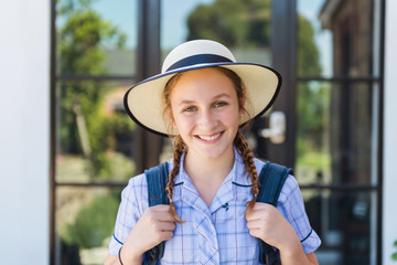 high school student with hat and backpack