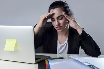 business woman working on laptop at office in stress suffering intense headache migraine