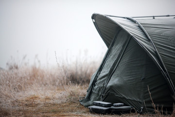 fishing tent with a fishing rod on the shore of Lake © andrii kornev