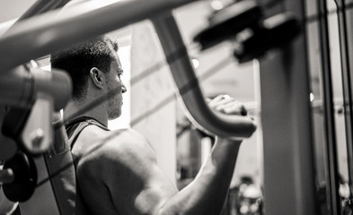 Bodybuilder athlete training inside american gym club
