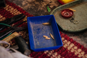 Kerala, India - February, 2016: Man working in gold smith factory. Process of engraving gold in...