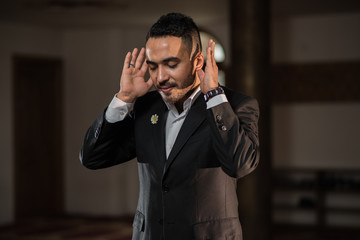 Successful business man starting to pray