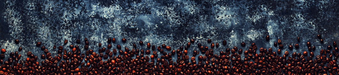 Coffee beans on a dark background of a concrete