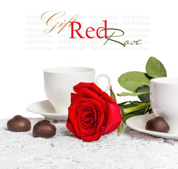 Beautiful red rose and cup of hot tea with chocolate