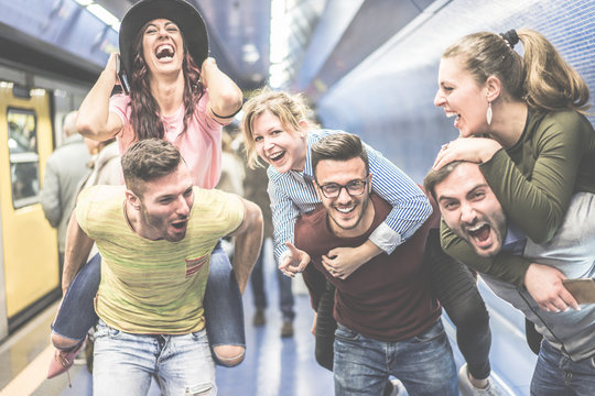 Group of party friends having fun in subway underground metro station