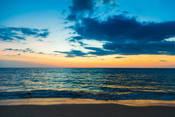 Naklejka na ściany i meble Sunset on sea beach with cloud
