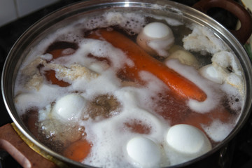 Cooking carrots and eggs in a pan