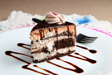 Chocolate cake or pastry in a white ceramic plate.