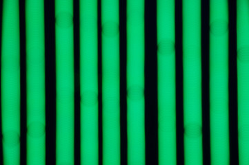 Bokeh background of green LED strips on black background