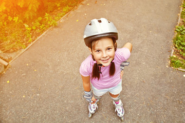 Little girl in roller skates at a park