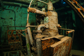 machinery in an underwater shipwreck is now home to a variety of marine life. fish live in the parts of the vessel that was deliberately sunk to create an artificial reef and habitat