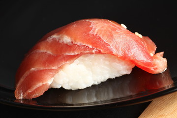 The japanese sushi on black color plate super macro shot represent the japanese food concept related idea.