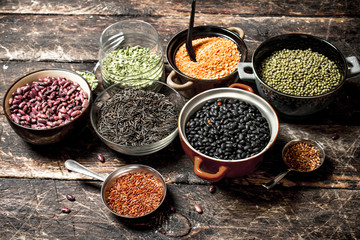 variety of bean seeds in a bowl . On a wooden table.