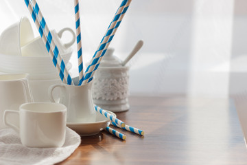 Set of white empty tableware on the wooden background