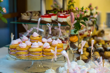 Obraz na płótnie Canvas Dessert table for a party. Ombre cake, cupcakes. Candy bar