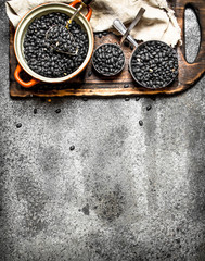 black beans in a bowl . On rustic background.