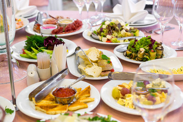 catering table set service with silverware, napkin and glass at restaurant before party