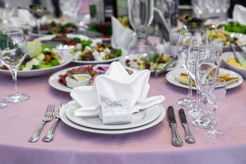 catering table set service with silverware, napkin and glass at restaurant before party