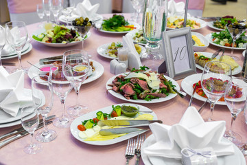 catering table set service with silverware, napkin and glass at restaurant before party