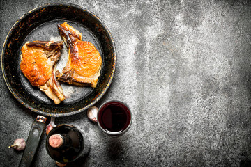 Meat grill. Fried pork in the pan with red wine.
