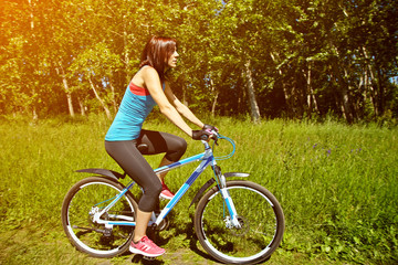 Fototapeta na wymiar Young woman and bike