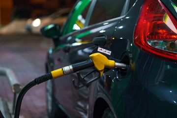 Fototapeta premium Car refueling on a petrol station at night