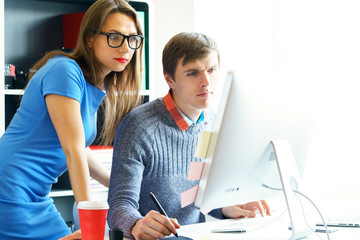 Beautiful young woman and man working from home office