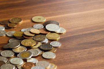 Different gold and silver collector's coins on the wooden table