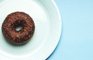 a paper party plate with a doughnut donut and copy space 
