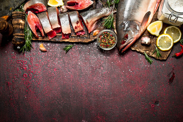 Pieces of fresh trout with spices and herbs.On rustic background.