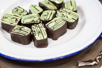 chocolate pralines on white plate