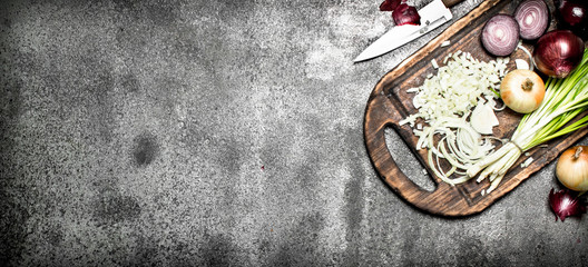Fresh chopped onion on the old Board. On rustic background.