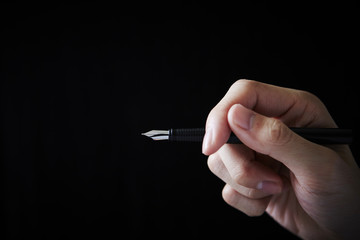 Hand holding fountain pen 