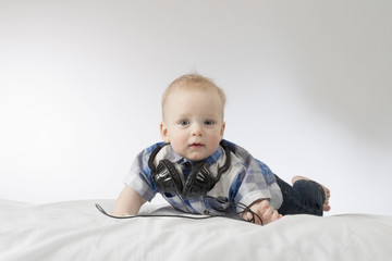 Fototapeta premium Little blond toddler with headphones