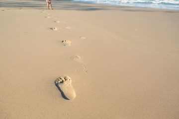 Footprints of a kid in the sand