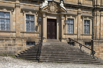 The historic entrance with stairs and ornamental railing