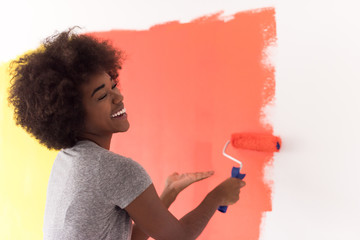 black woman painting wall