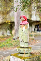 Old Jizo stone statue standing in Matsushima
