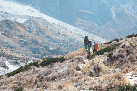 Mountain Slope and Group of Climbers walking on Footpath