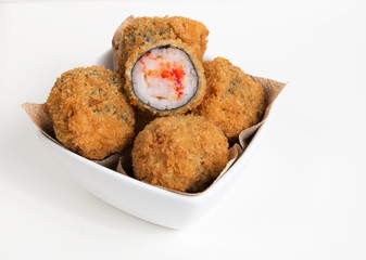 Tempura maki balls, Japanese deep fried sushi balls made of crab stick, shrimp and caviar on white background