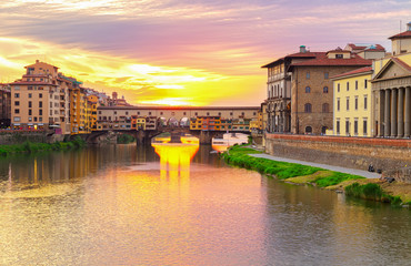 famous bridge Ponte Vecchio over Arno river at sunset, Florence, Italy