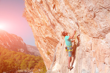 Mature male Climber making Move on vertical Rock