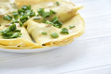Fried puncakes with green onion on white background