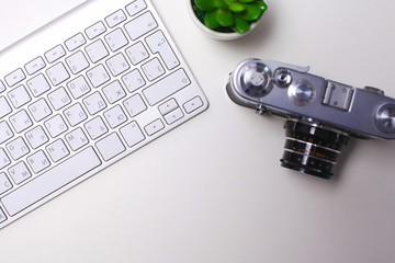 Top view of office graphic design pen mouse with laptop wireless mouse and vintage old camera on white table. Concept graphic design workplace