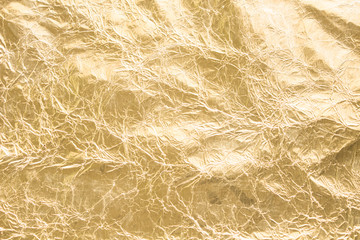 Gold wrinkled paper texture abstract background