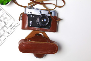 Top view of office graphic design pen mouse with laptop wireless mouse and vintage old camera on white table. Concept graphic design workplace