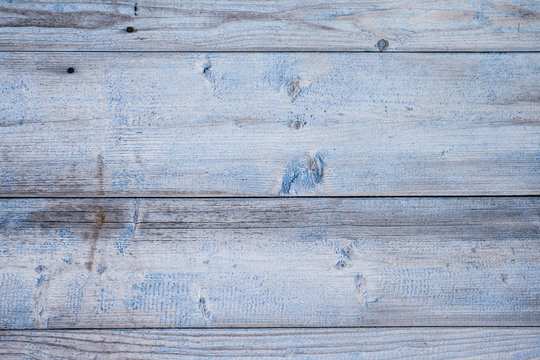 Light blue cracked wooden background with aged texture