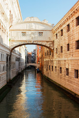 Fototapeta na wymiar Bridge of Sighs over canal, sunny day in Venice, Italy